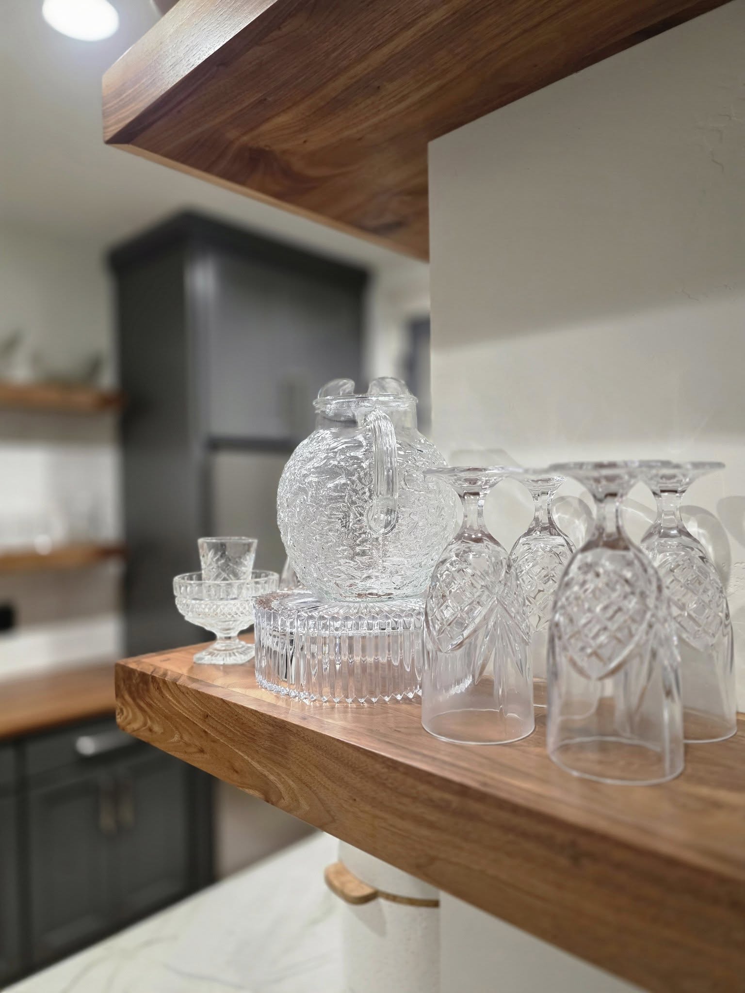 Crystal glassware on wooden kitchen shelf