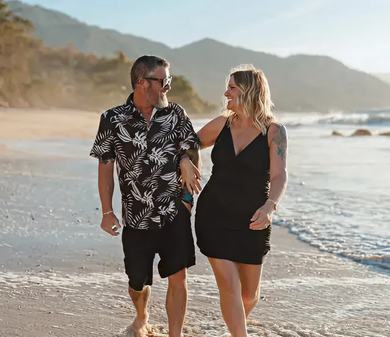 Man and woman strolling by ocean