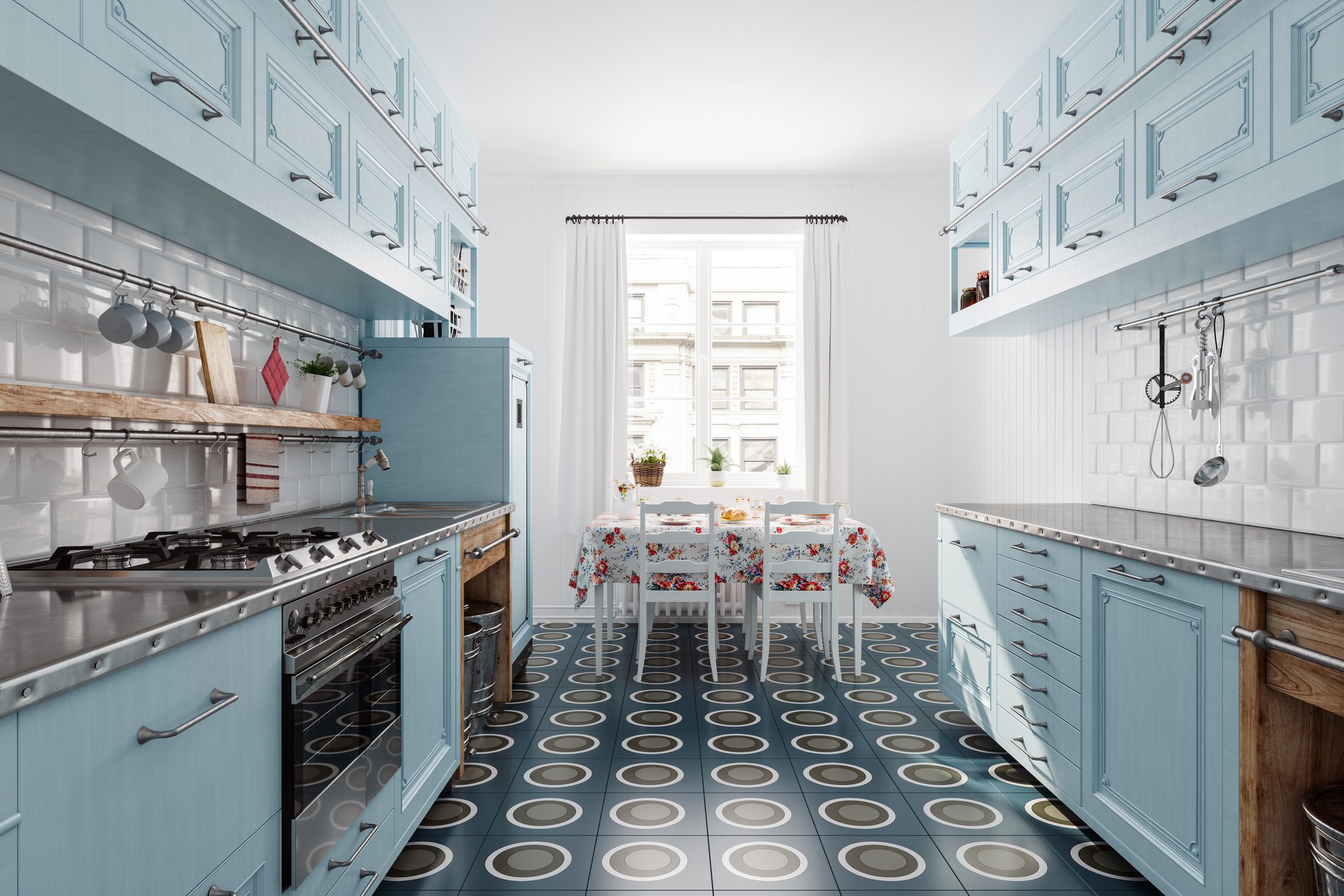 Bright kitchen with blue cabinets and patterned tile floor.