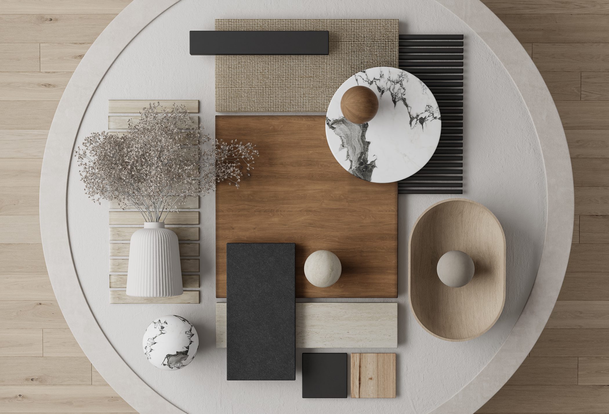 A stylish flat lay of neutral-toned home decor and material samples on a round table.