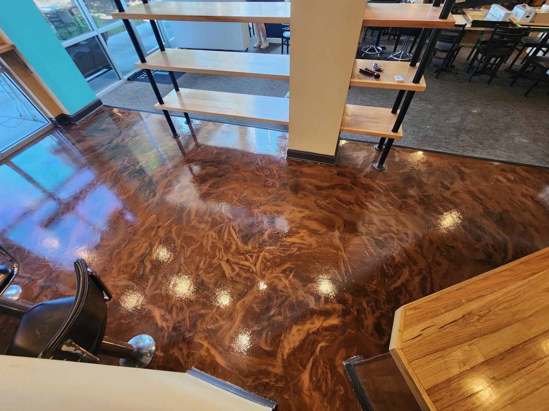 Highly polished wooden floor reflecting ceiling lights.